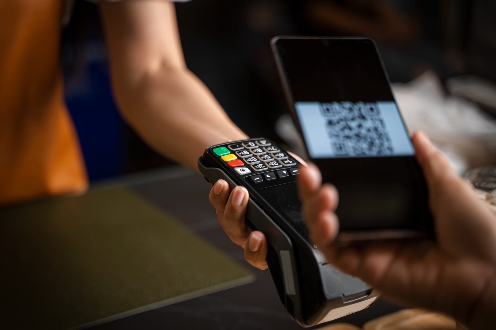 Close up woman hand holding using smartphone while making contactless payment at cafe,Mobile payment.